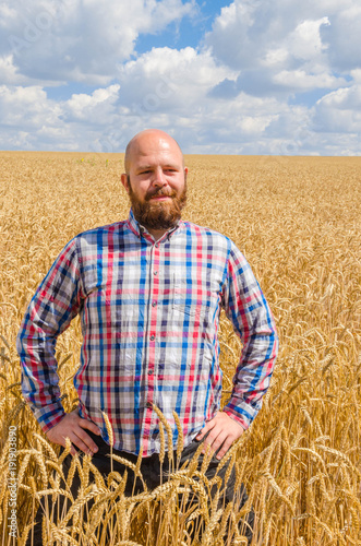 Farmer standing in wheat field © valerii kalantai