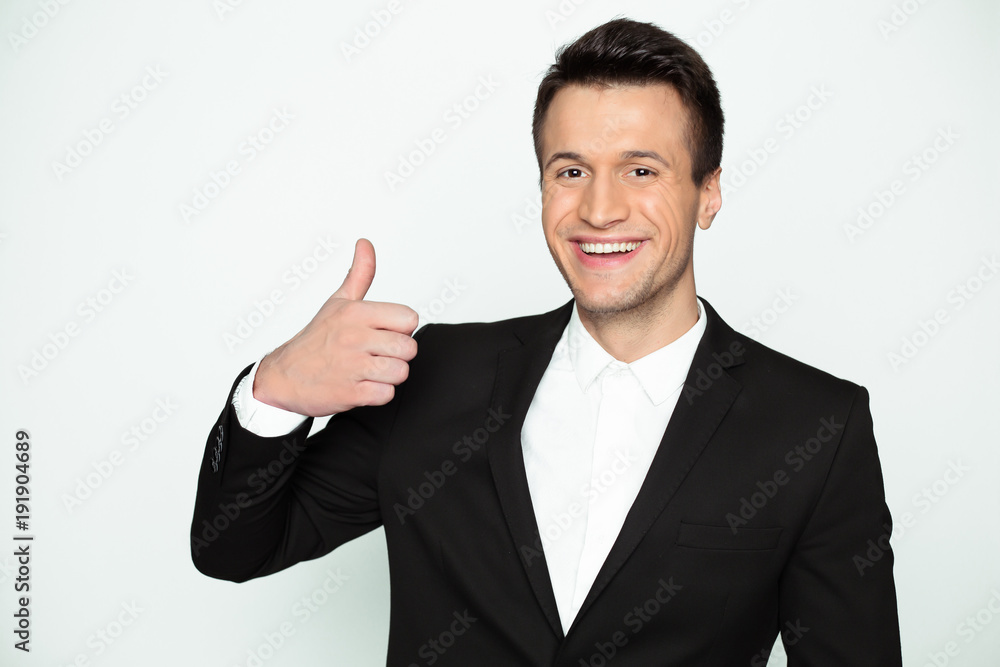 This is a good result. Stylish handsome smiling modern businessman in smart casual wear looks at the camera and picks up his thumb up. This is a good result. Stylish handsome smiling modern businessman in smart casual wear looks at the camera and picks up his thumb up.