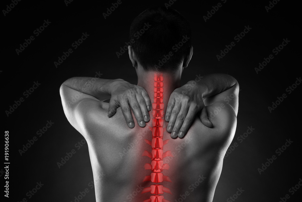 Pain in the spine, a man with backache, injury in the human back and neck Pain in the spine, a man with backache, injury in the human back and neck