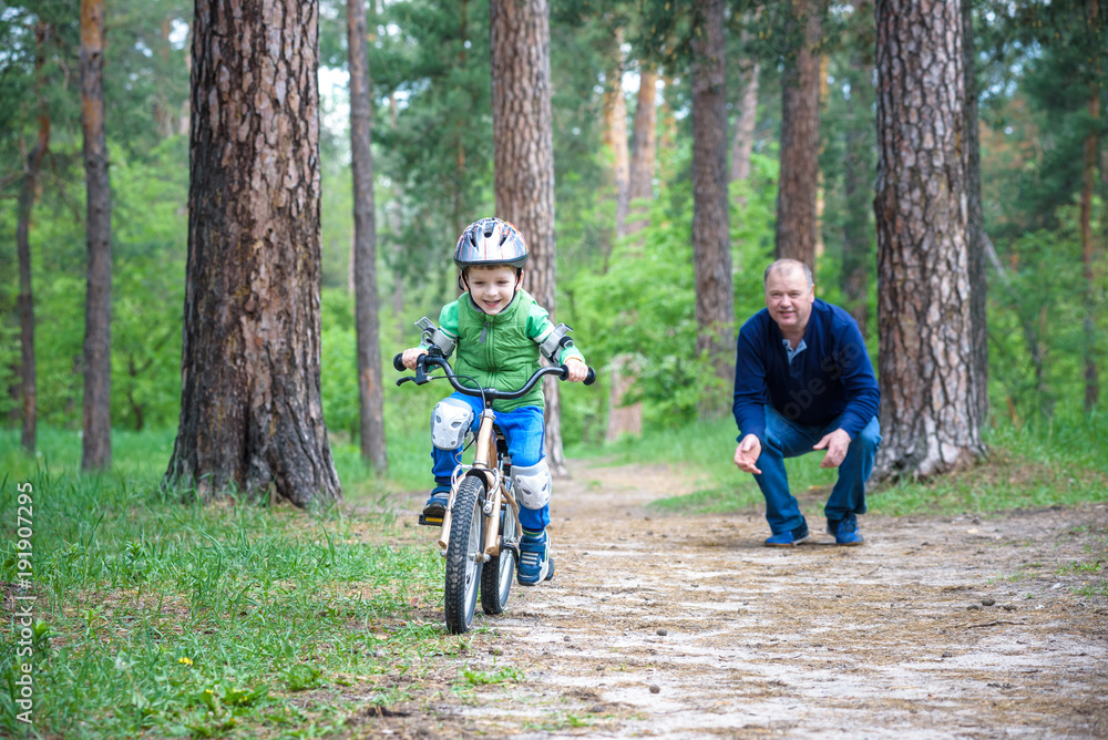 Little kid boy of 3 years and his father in autumn forest with a Little kid boy of 3 years and his father in autumn forest with a