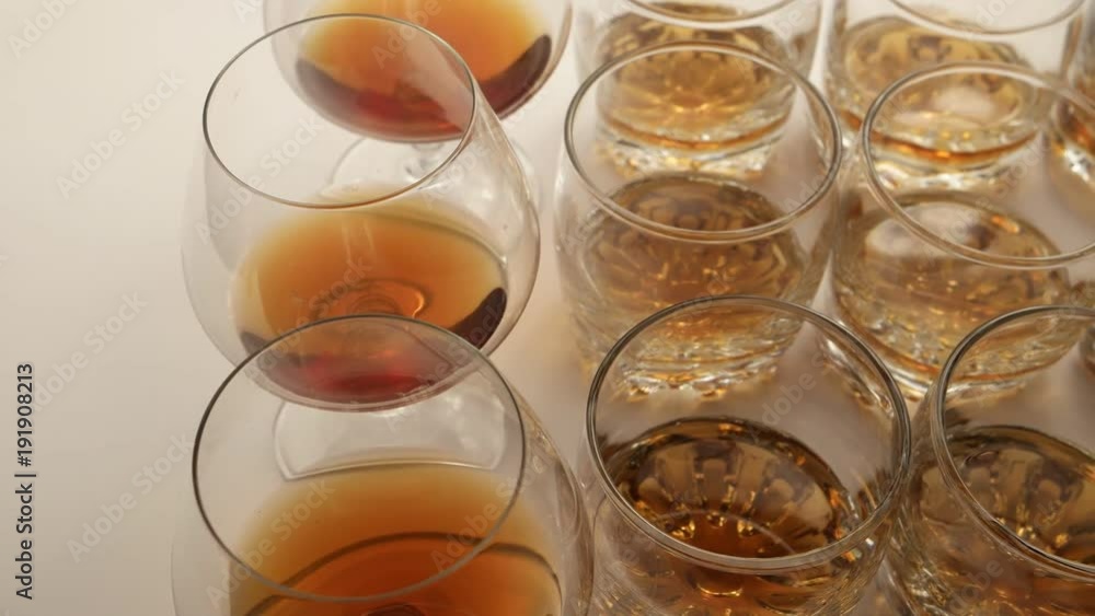 The glasses of beverage move on the surface of the table