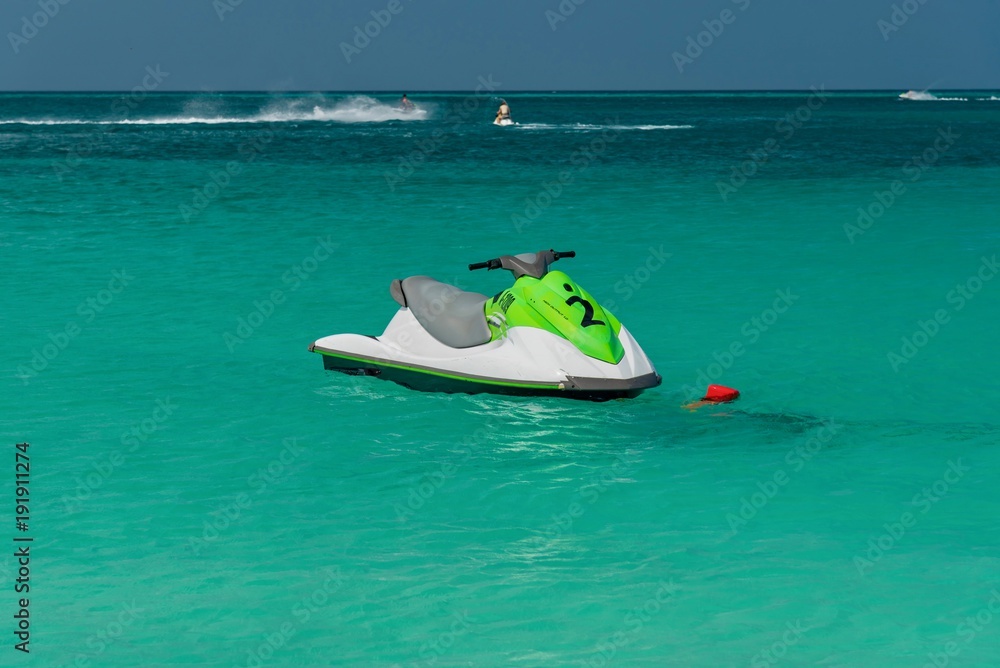 canoes and jet skis on the turquoise Caribbean sea