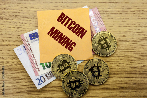 Bitcoins, Bit Coin on Euro, Dollars notes witch sticky note on wooden background, BITCOIN MINING photo