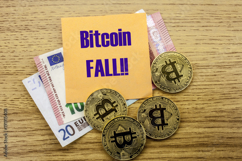 Bitcoins, Bit Coin on Euro, Dollars notes witch sticky note on wooden background, BITCOIN FALL. photo