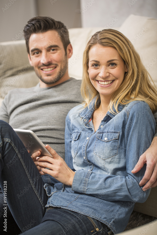 young couple at home websurfing with tablet young couple at home websurfing with tablet