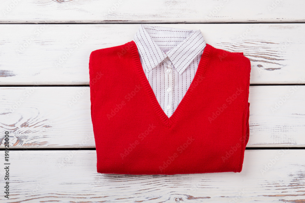 Female red sweater with white collar. Women sweater shirt folded on white  wooden background. Brand clothes for woman. Stock Photo | Adobe Stock