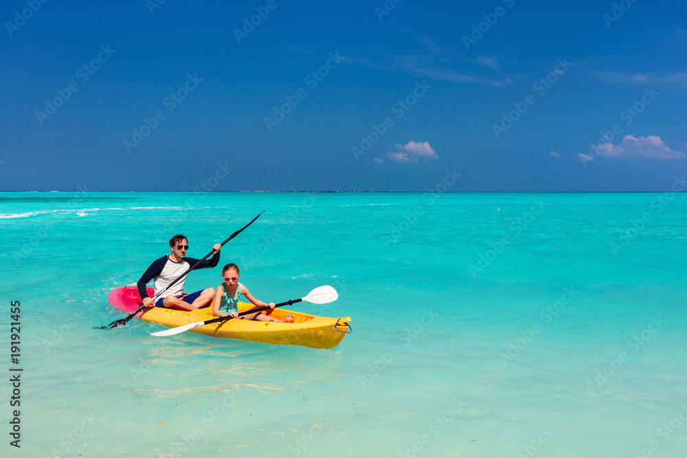 Family kayaking at tropical ocean