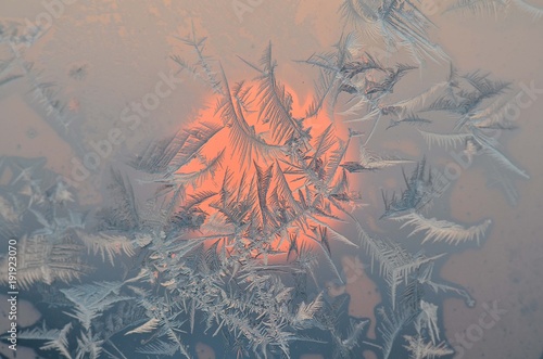 Fototapeta Naklejka Na Ścianę i Meble -  Crystals of frosty pattern on the window in the sun