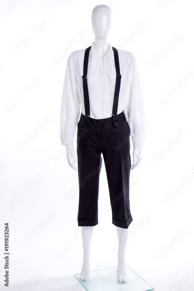 White shirt and black trousers with suspenders. Female mannequin dressed in blouse and capri with braces. White shirt and black trousers with suspenders. Female mannequin dressed in blouse and capri with braces.