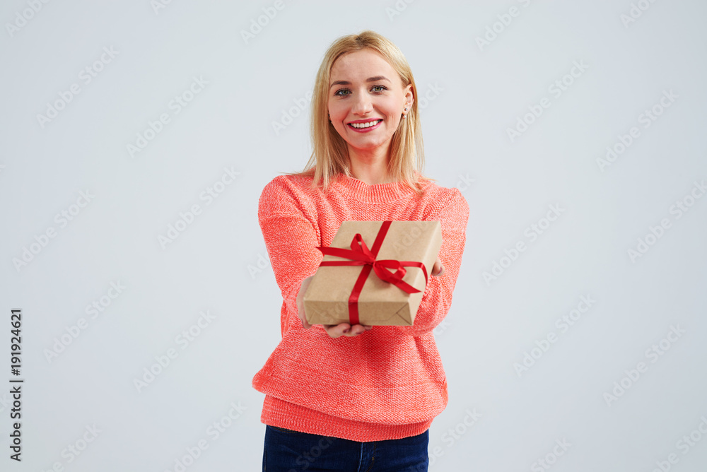 woman smiling and holding gift box woman smiling and holding gift box