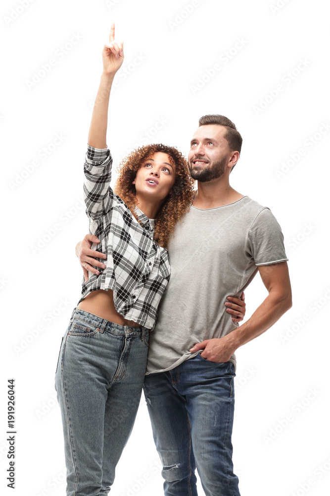 oung couple looking up and pointing upwards oung couple looking up and pointing upwards