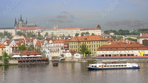 A boat on Vltava River with Prague castle as background