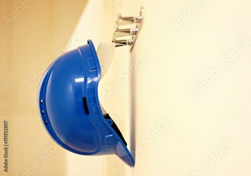 Blue protective helmet on the wall hanging
