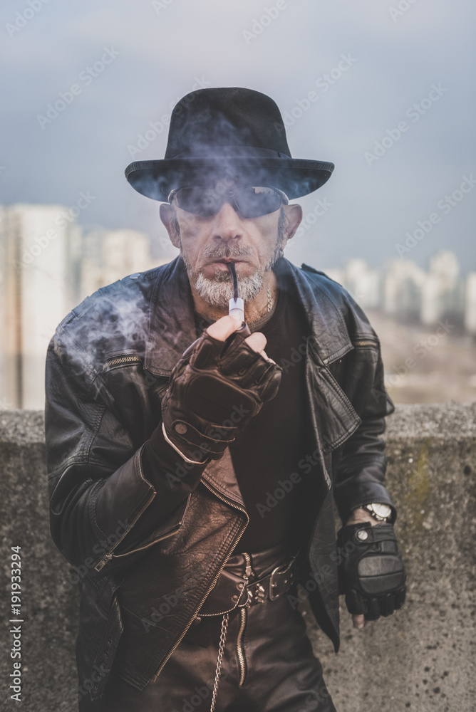 Portrait of fashionable man with the smoking pipe,selective focus Portrait of fashionable man with the smoking pipe,selective focus