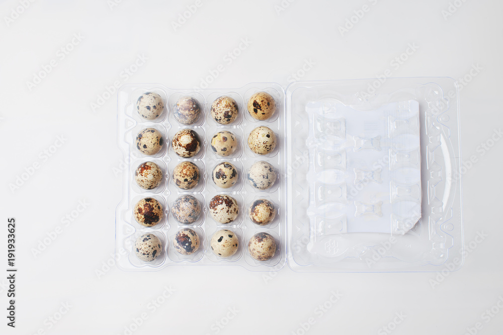 quail eggs lie in a plastic tray on a white background. preparation for Easter