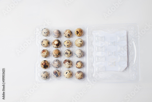 quail eggs lie in a plastic tray on a white background. preparation for Easter