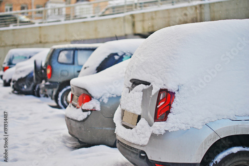 fresh white snow covered cars after snowfall. Winter urban scene. © raisondtre