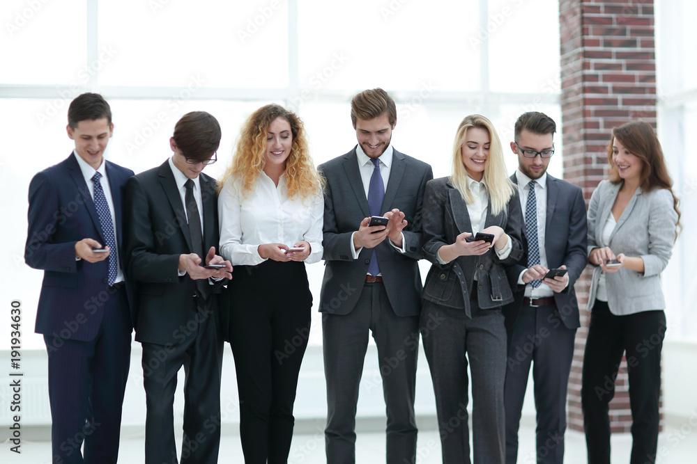business team looking to smartphone in office business team looking to smartphone in office