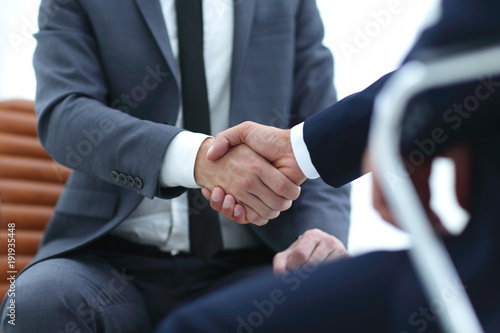 wo focused coworkers sitting together in a modern office © ASDF