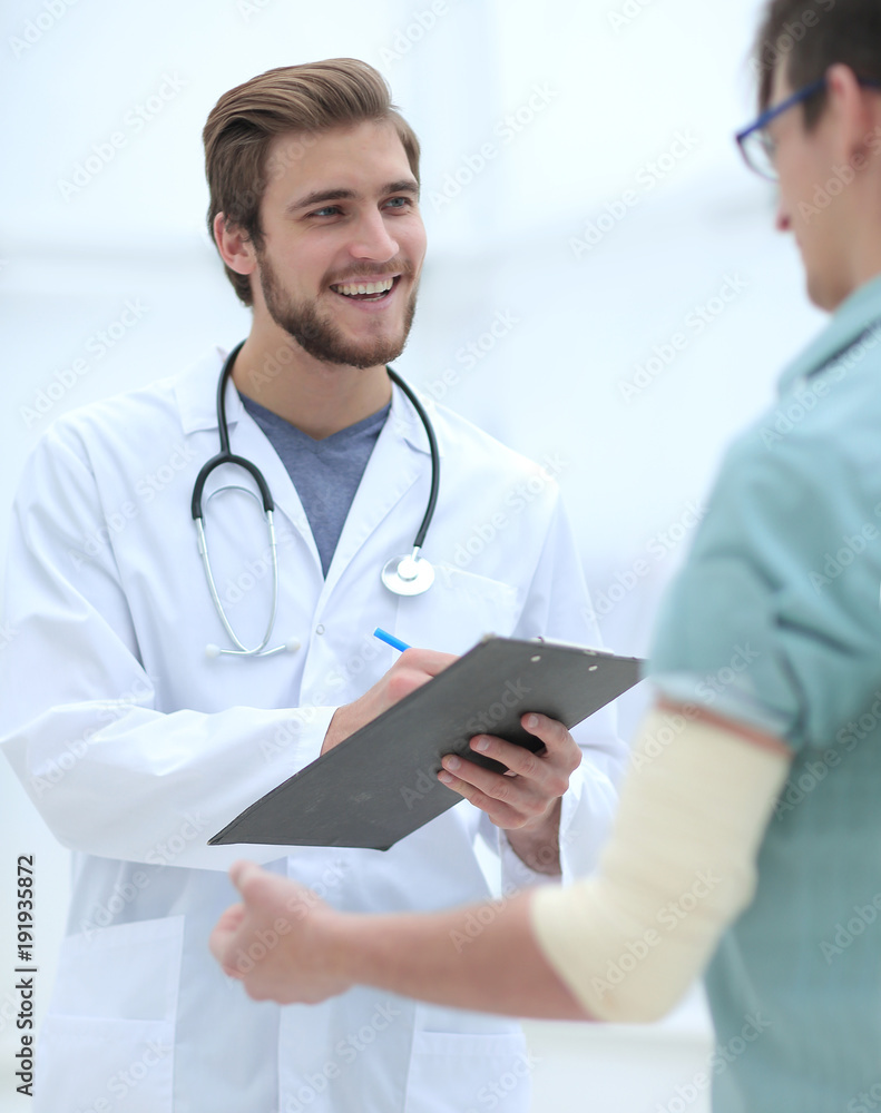 podiatrist writing a prescription to her patient. podiatrist writing a prescription to her patient.