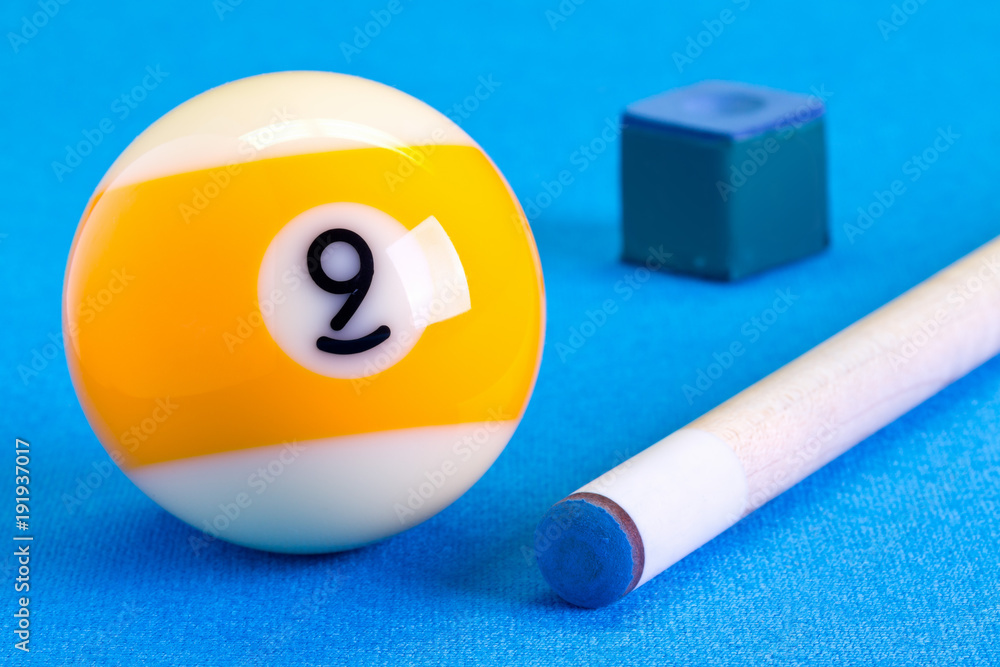Billiard pool game nine ball with chalk and cue on billiard table Billiard pool game nine ball with chalk and cue on billiard table