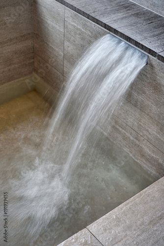 Close up section of onsen bathtub and faucet