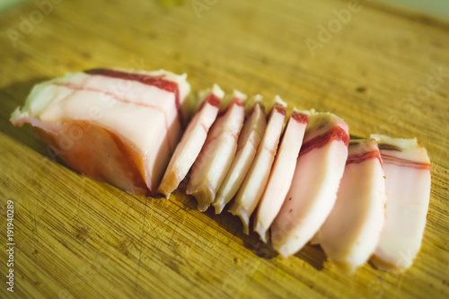 Salted Lard Bacon slices on wooden board photo