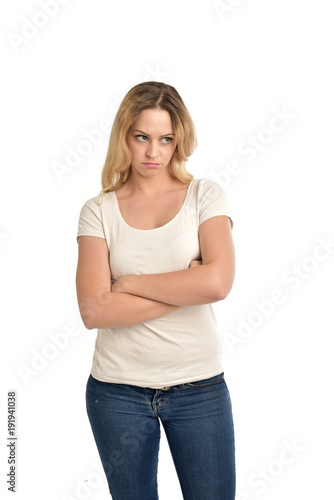 3/4 portrait of blonde lady wearing white shirt, upset expression. isolated on white studio background.
