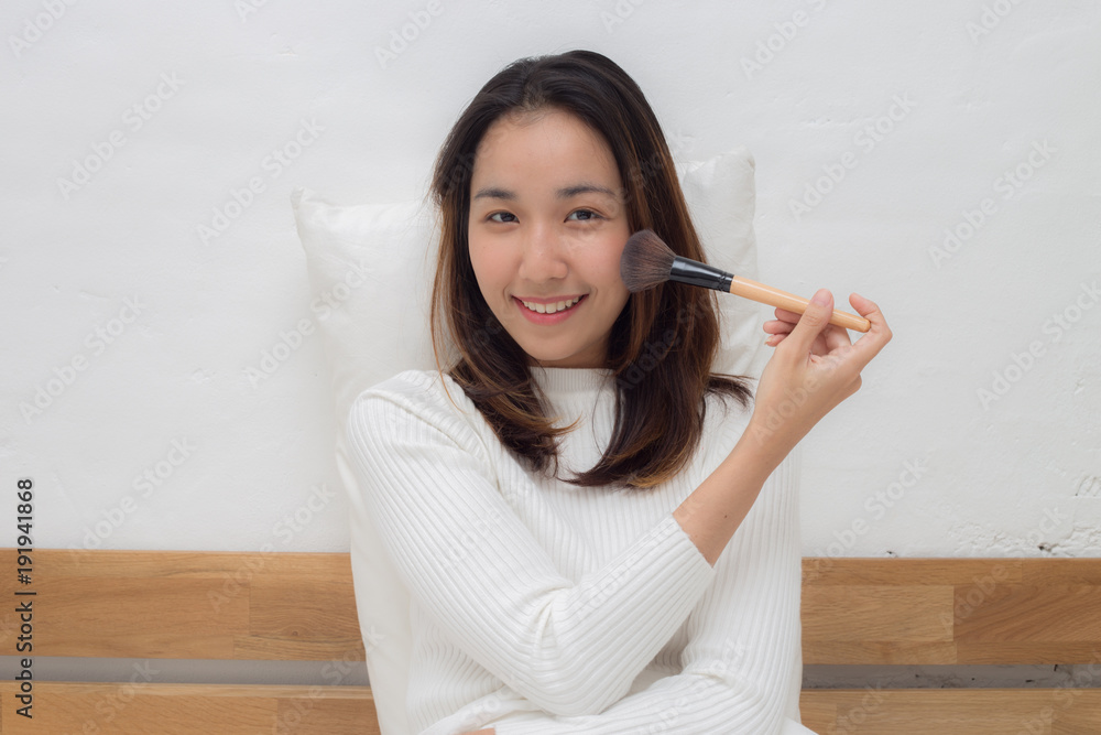 Beauty Asian Woman smile with make up brush after wake up Beauty Asian Woman smile with make up brush after wake up