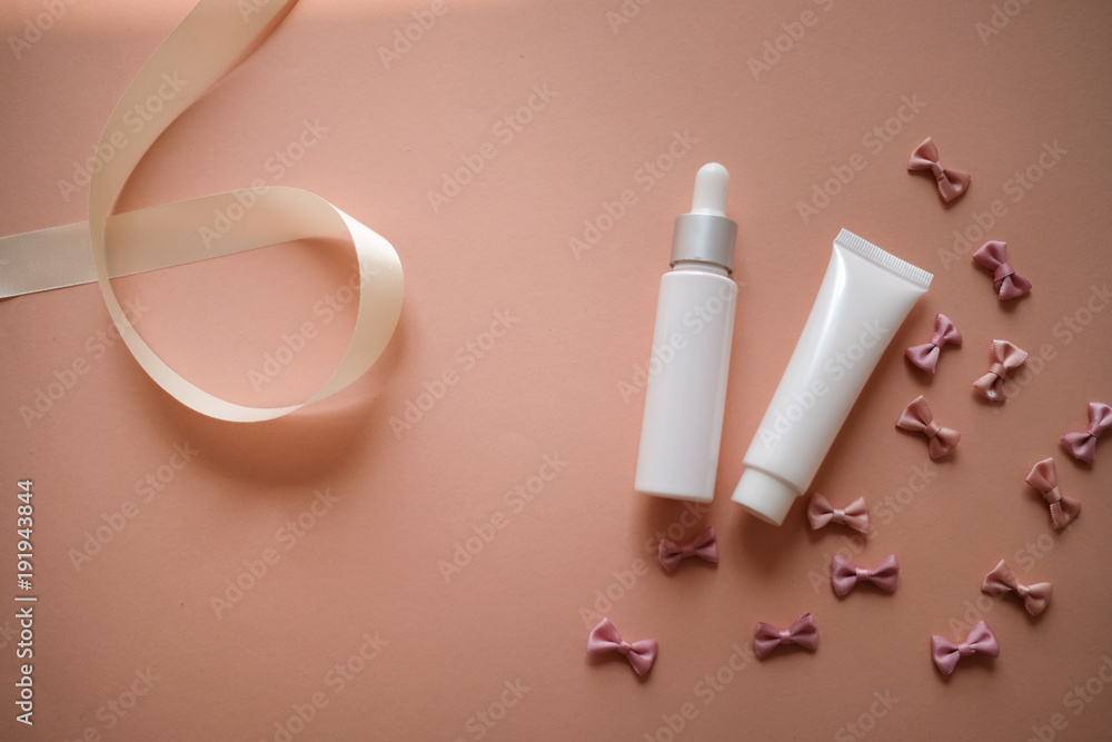 bows background on pink with cosmetic product packaging bottle. pastel ribbon and pretty girly. abstract wallpaper pattern. bows background on pink with cosmetic product packaging bottle. pastel ribbon and pretty girly. abstract wallpaper pattern.