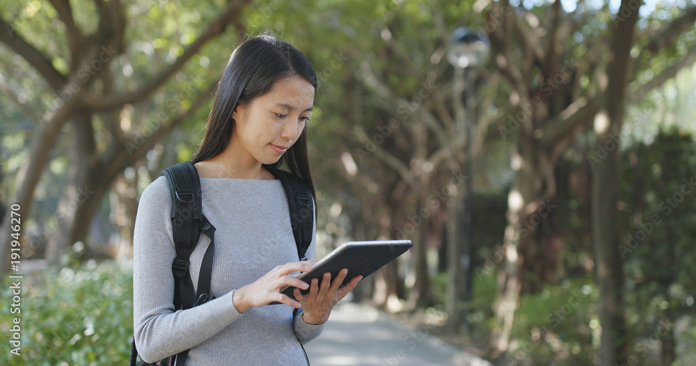 Young Woman use of tablet computer at outdoor Young Woman use of tablet computer at outdoor