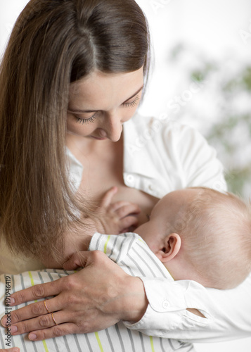 Young mother holding her ne...