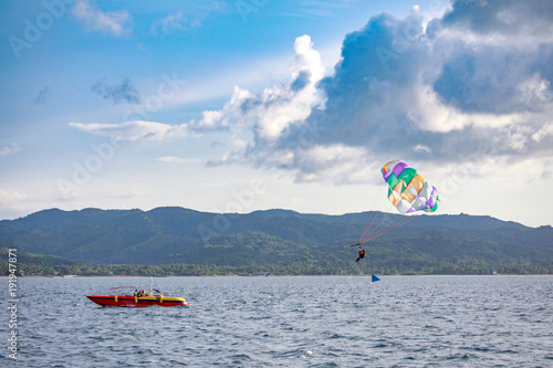 Unidentified tourist doing parachute sailing recreational activity in Boracay Island, Aklan, Philippines