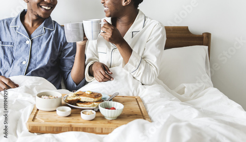 Vászonkép A couple having breakfast in bed