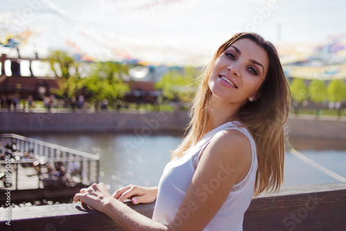Free Download Portrait of happy young woman on a walk. Summer in the city - GFXLoad