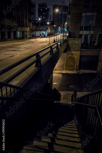 City tunnel bridge street corner with stairs at night.