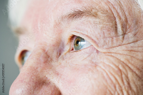 Closeup side portrait of white elderly woman eyes