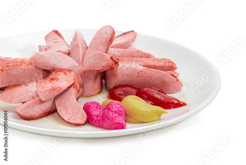 Canvas Print Fried vienna sausages with various condiments on white dish
