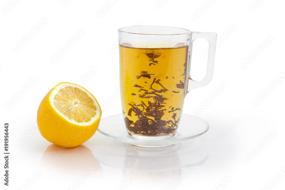 Glass cup of black tea during brewing and lemon Glass cup of black tea during brewing and lemon