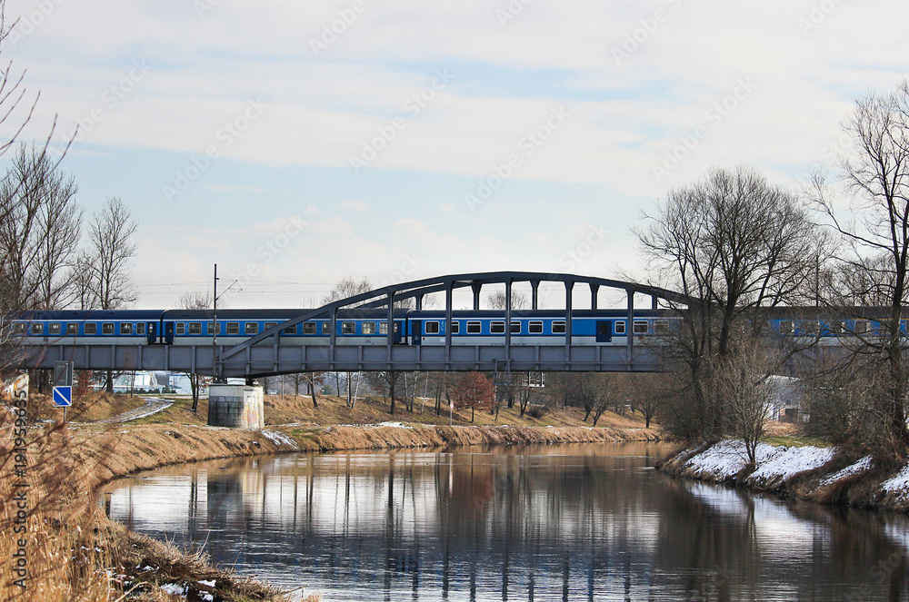 Fototapeta premium Train on old bridge above river Vltava, Czech landscape