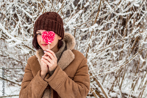 young woman in winter forest portrait in hat. concept of a positive outlook on the world photo