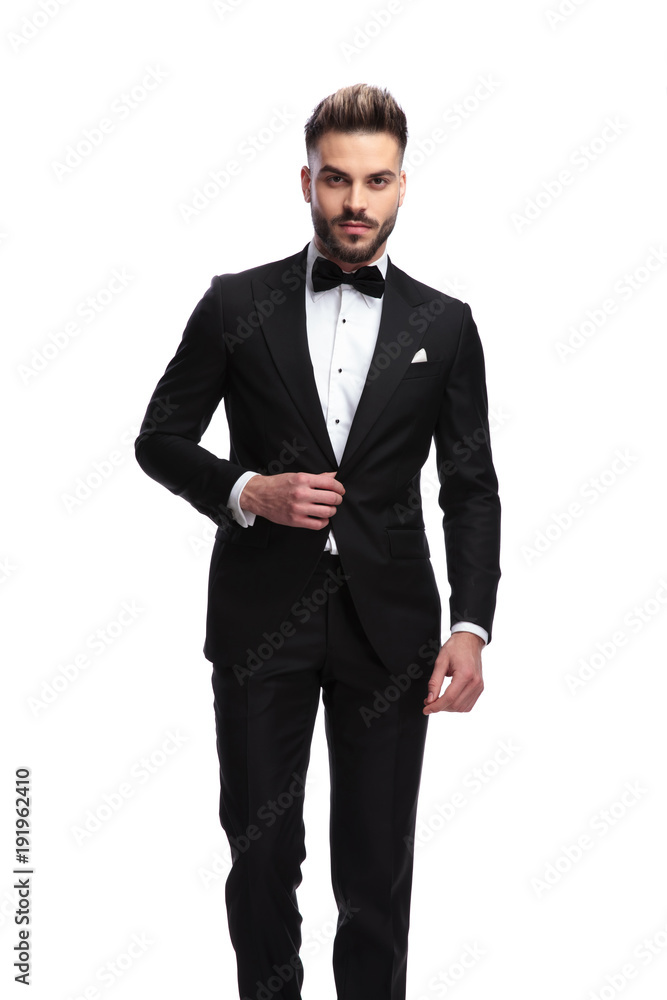 portrait of a sexy man in tuxedo holding his collar portrait of a sexy man in tuxedo holding his collar