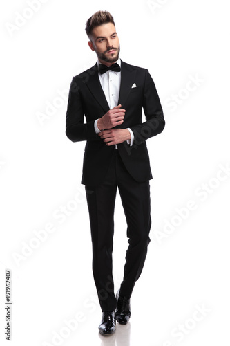 Photos young sexy man in tuxedo and bowtie fixing his sleeve