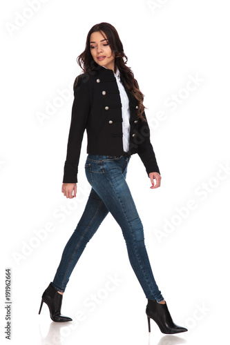 casual woman in black jacket walking