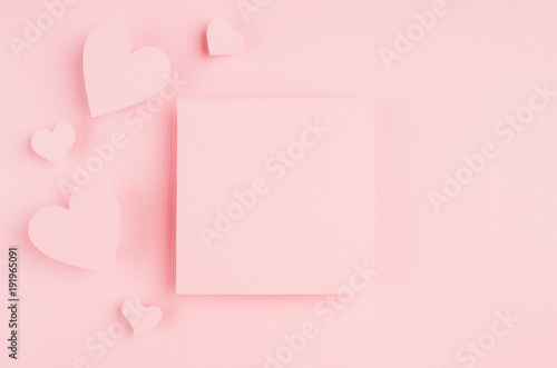 Valentines day background with blank page and paper hearts on gentle pink color background. © finepoints