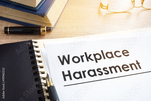 Documents about workplace harassment in an office. photo