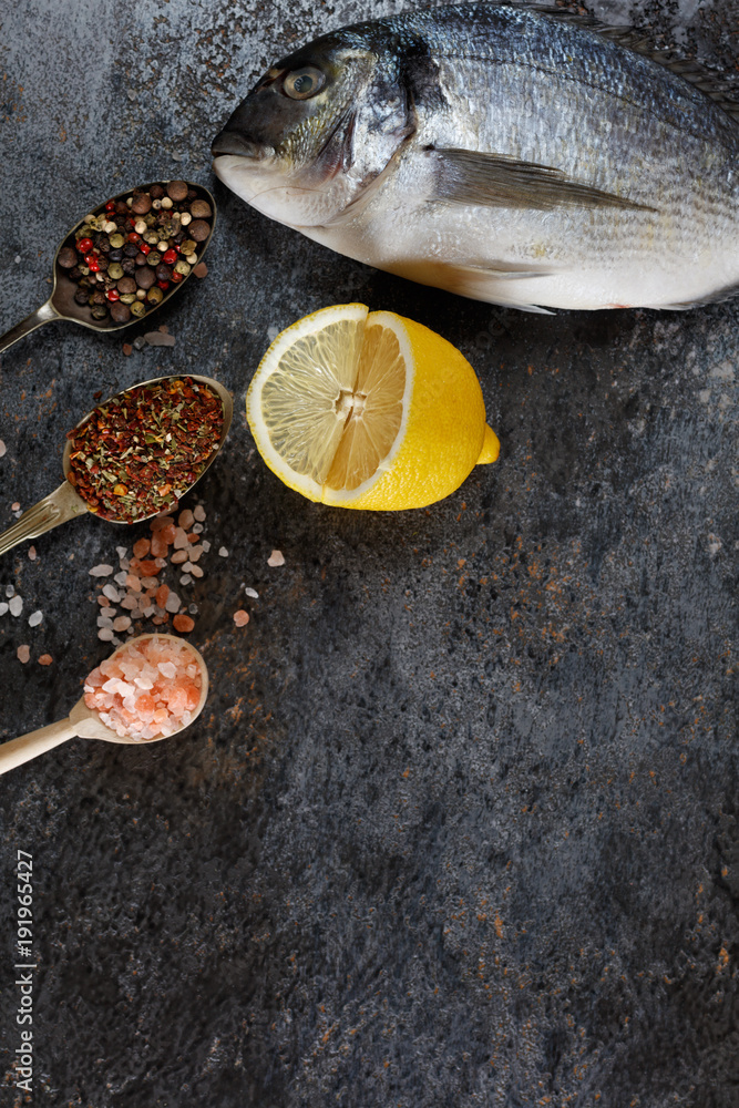 Top view of fresh fish dorado on grunge textured background. Copyspace.