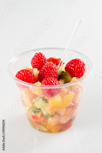 fruit salad in takeaway clear plastic cup in white background