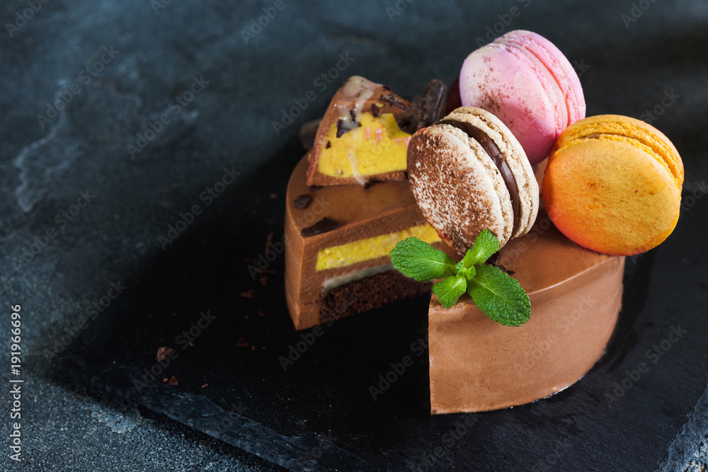 Chocolate cheesecake with banana filling decorated with macarons and toffee Chocolate cheesecake with banana filling decorated with macarons and toffee