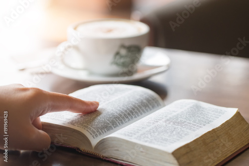 Woman's hands on a Bible, studying and reading.